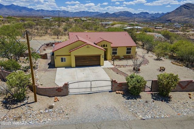 1888 Circulo Guatemala, Rio Rico, AZ 85648 - view of front of property with a gate, a tiled roof, a mountain view, and a fenced front yard