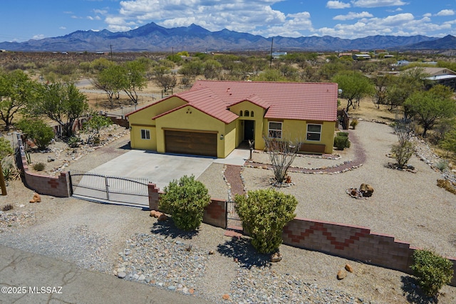 1888 Circulo Guatemala, Rio Rico, AZ 85648 - view of front of house featuring a gate, a mountain view, a tile roof, concrete driveway, and stucco siding