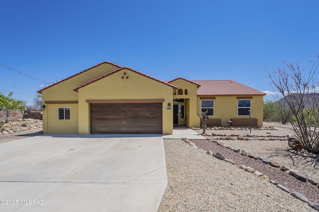 1888 Circulo Guatemala, Rio Rico, AZ 85648 - mediterranean / spanish house with stucco siding, a tiled roof, a garage, and concrete driveway