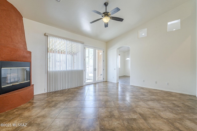 1888 Circulo Guatemala, Rio Rico, AZ 85648 - unfurnished living room with arched walkways, lofted ceiling, and ceiling fan
