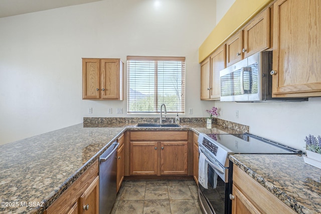 1888 Circulo Guatemala, Rio Rico, AZ 85648 - kitchen featuring appliances with stainless steel finishes, a sink, stone finish flooring, and brown cabinets