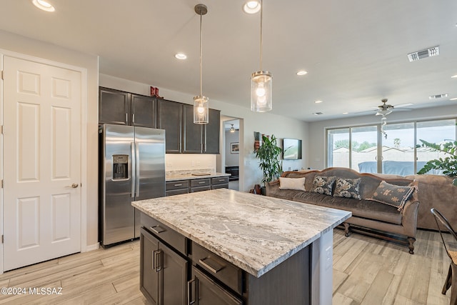 kitchen featuring decorative light fixtures, dark brown cabinets, light hardwood / wood-style flooring, stainless steel refrigerator with ice dispenser, and a center island