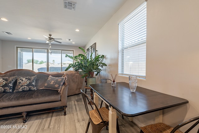 dining area featuring light wood-type flooring and ceiling fan