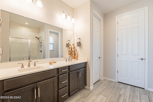 bathroom featuring vanity, an enclosed shower, and hardwood / wood-style flooring