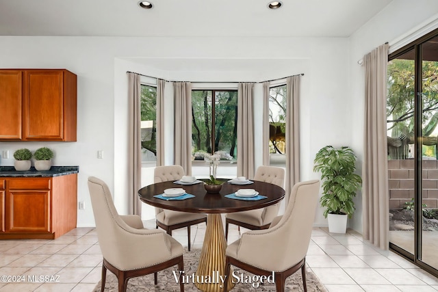 dining space with a healthy amount of sunlight and light tile patterned floors