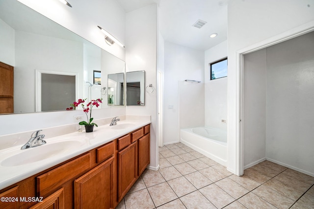 bathroom featuring vanity, a tub to relax in, and tile patterned floors