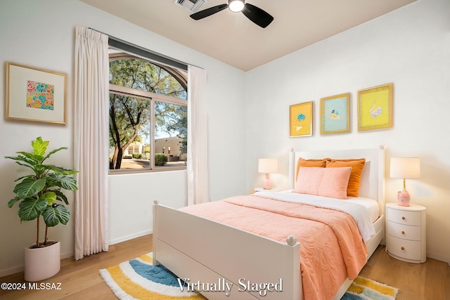 bedroom with light hardwood / wood-style floors and ceiling fan