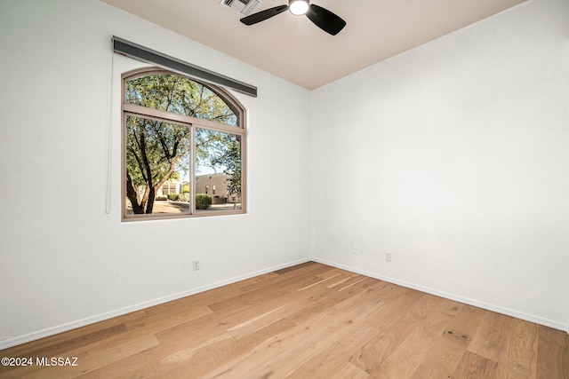 empty room with light hardwood / wood-style flooring and ceiling fan