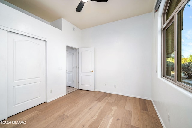 unfurnished bedroom with a closet, ceiling fan, and light wood-type flooring