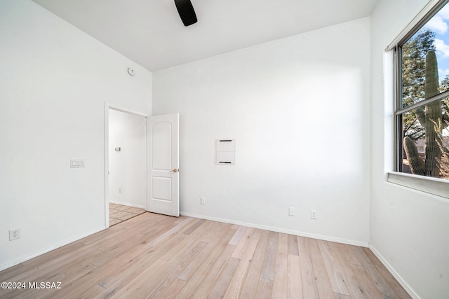 unfurnished room with light wood-type flooring and ceiling fan