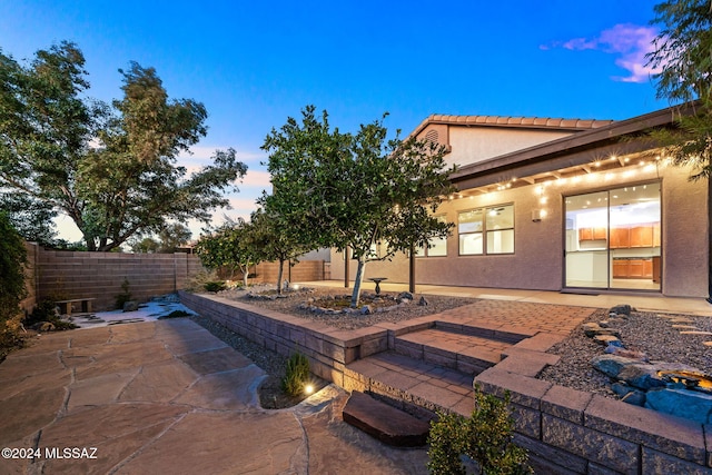 view of patio terrace at dusk