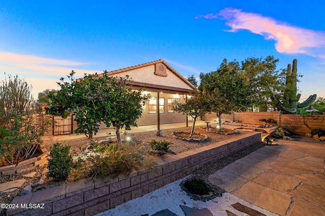 view of patio terrace at dusk