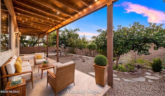 patio terrace at dusk featuring an outdoor hangout area