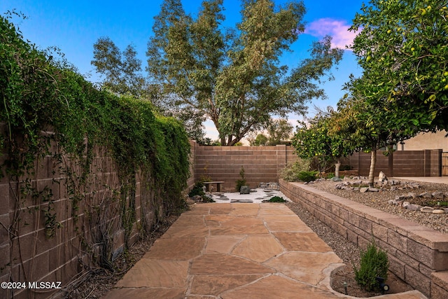 view of patio terrace at dusk