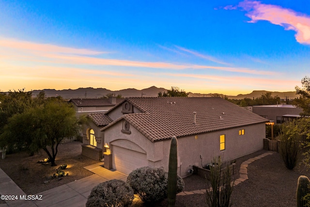 view of front of house with a mountain view and a garage