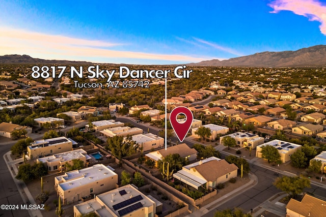 aerial view at dusk featuring a mountain view