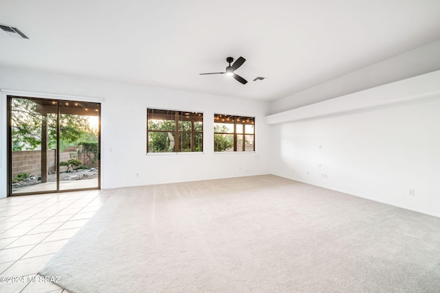 spare room with light colored carpet and ceiling fan