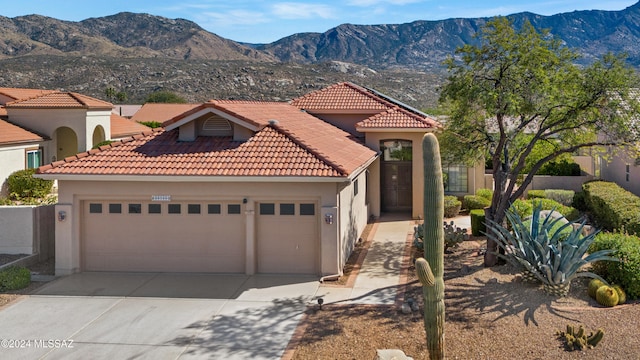 mediterranean / spanish home featuring a mountain view and a garage