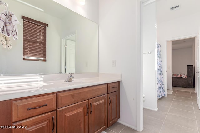 bathroom featuring tile patterned flooring and vanity