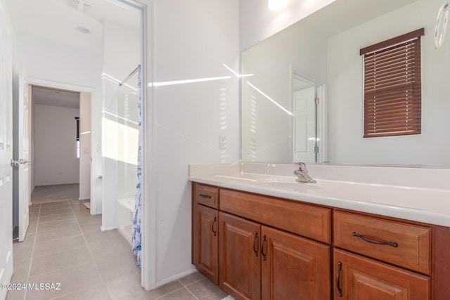 bathroom with shower / bath combo with shower curtain, tile patterned flooring, and vanity