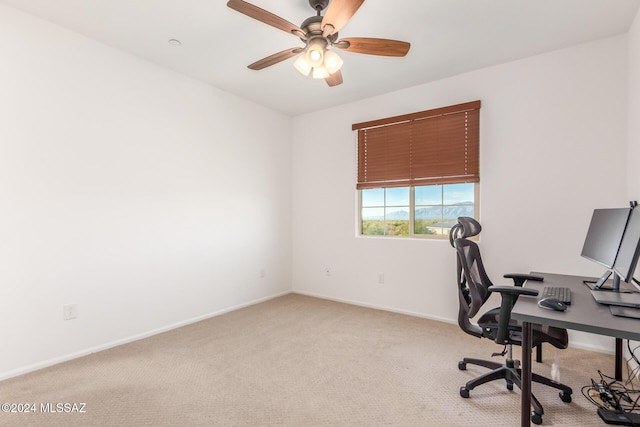 carpeted office featuring ceiling fan