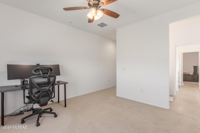 carpeted office featuring ceiling fan