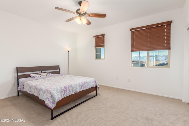 bedroom featuring ceiling fan and light colored carpet