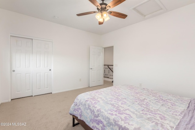 bedroom featuring light carpet, a closet, and ceiling fan