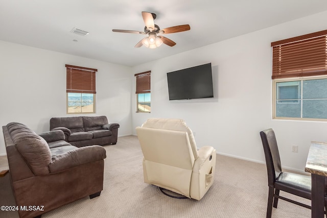 living room featuring ceiling fan and light colored carpet