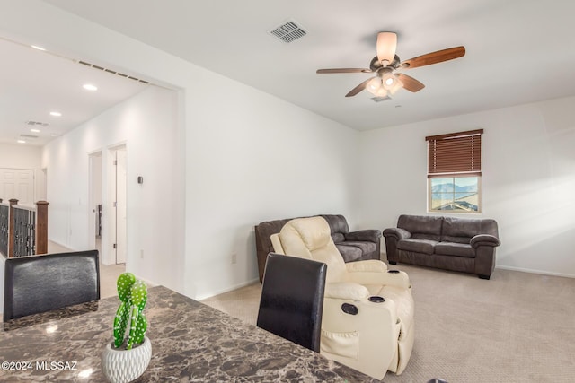 living room with light colored carpet and ceiling fan