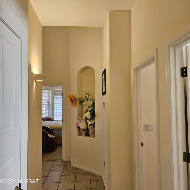 hallway with tile patterned flooring