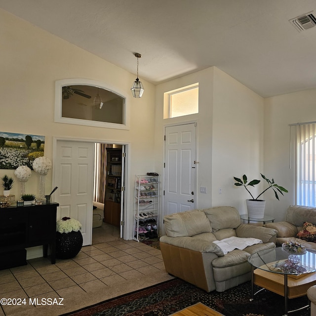 tiled living room with a towering ceiling