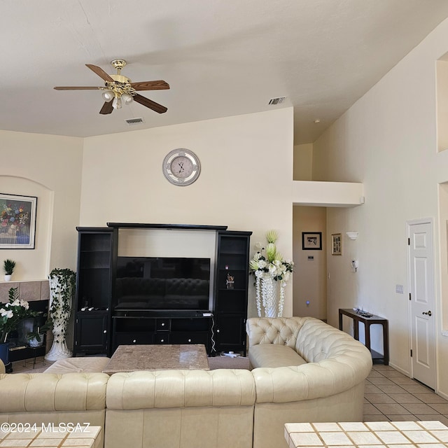 living room with vaulted ceiling, light tile patterned flooring, and ceiling fan