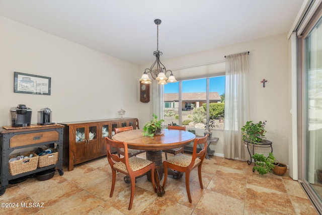 dining area featuring a notable chandelier