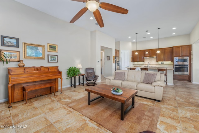 living room featuring ceiling fan and sink