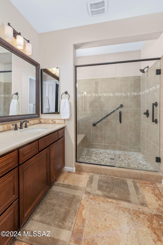 bathroom with vanity and an enclosed shower