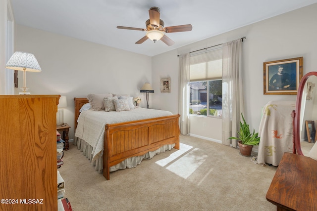 bedroom featuring ceiling fan and light carpet