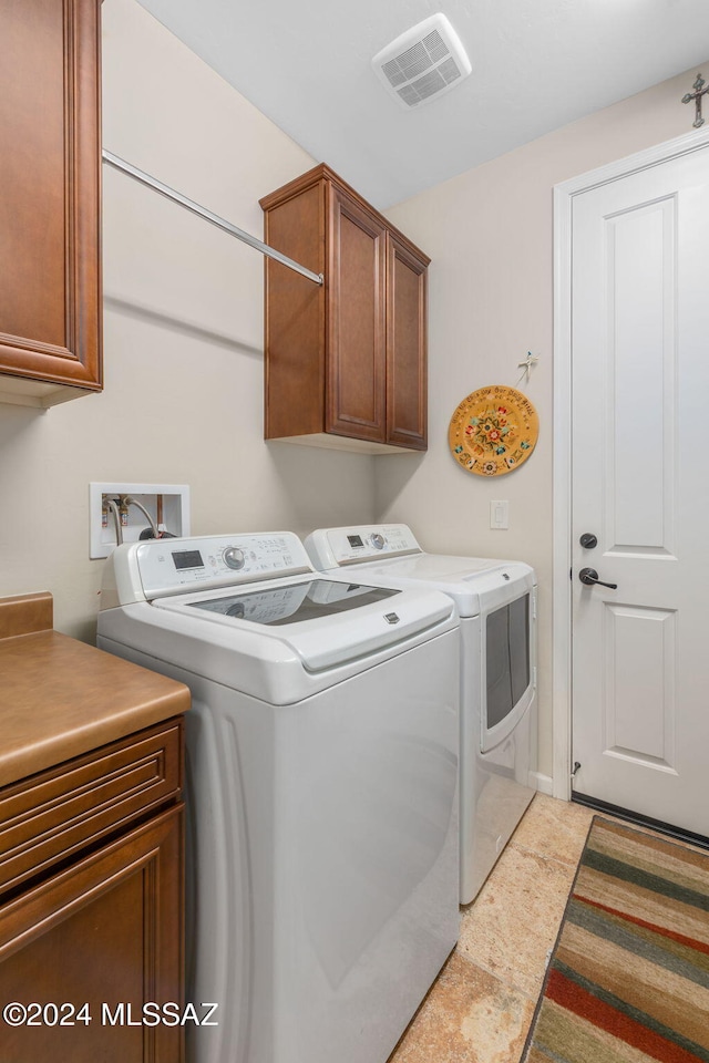 laundry area with cabinets and independent washer and dryer