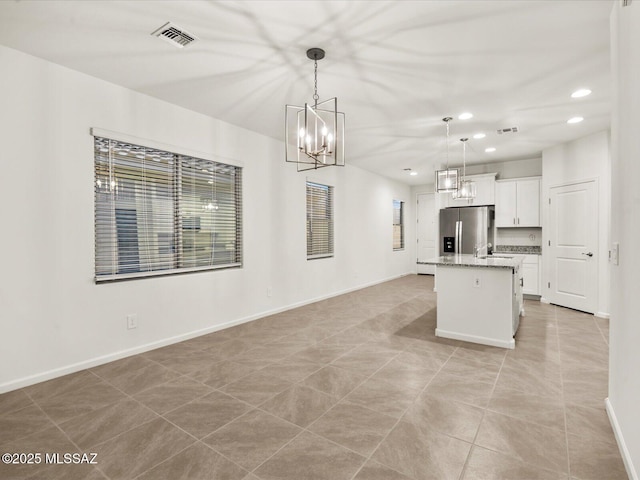 kitchen featuring recessed lighting, an inviting chandelier, stainless steel fridge, visible vents, and decorative light fixtures