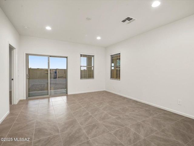 unfurnished room with recessed lighting, visible vents, tile patterned floors, and baseboards