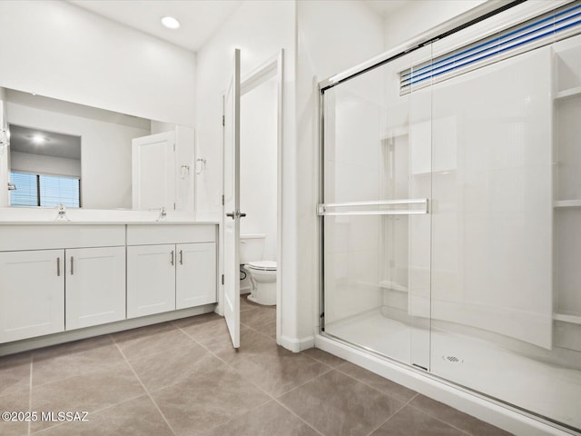 bathroom featuring a shower stall, toilet, tile patterned flooring, and a sink