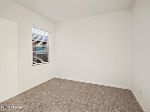 unfurnished room featuring baseboards and carpet floors