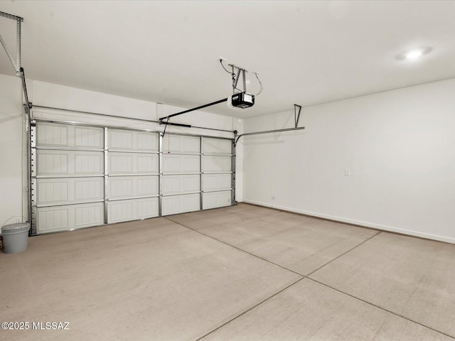 garage with a garage door opener and baseboards