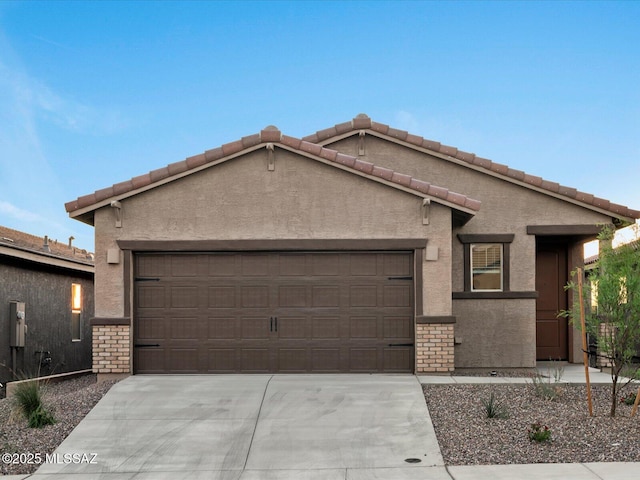 ranch-style house with driveway, an attached garage, and stucco siding