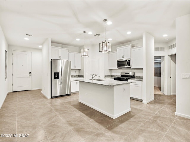 kitchen with a sink, appliances with stainless steel finishes, and visible vents