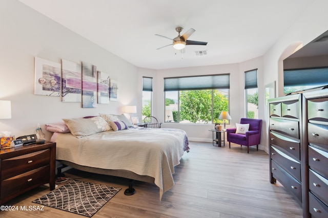 bedroom with light hardwood / wood-style floors and ceiling fan