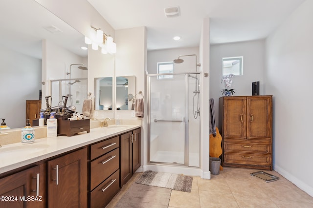 bathroom featuring tile patterned flooring, vanity, and an enclosed shower