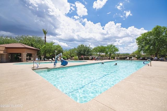 view of swimming pool with a patio