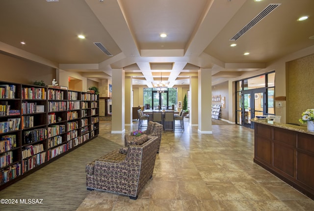 hallway featuring a chandelier, beam ceiling, french doors, and coffered ceiling