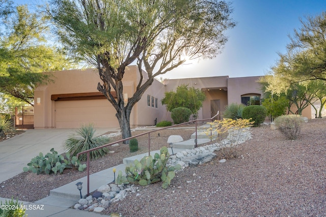 pueblo-style home with a garage